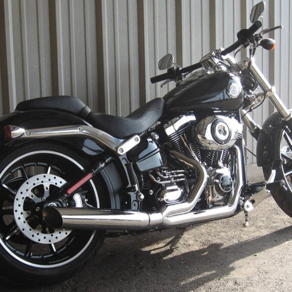 Black motorcycle parked against a metallic wall