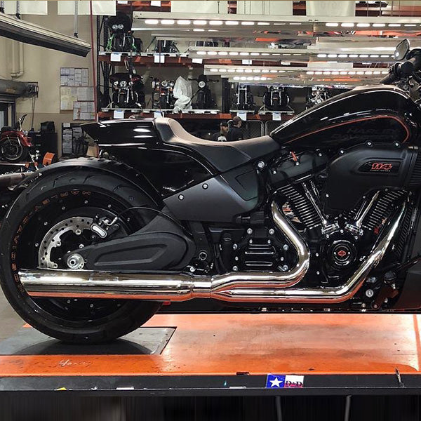 Black motorcycle on a lift in a garage setting