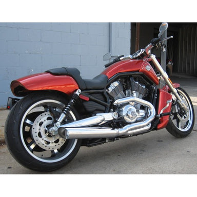 Red motorcycle parked on a concrete surface with a gray wall in the background