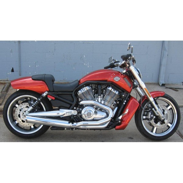 Red motorcycle parked on a concrete surface with a gray wall in the background