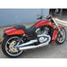 Red motorcycle parked on a concrete surface with a blue wall in the background