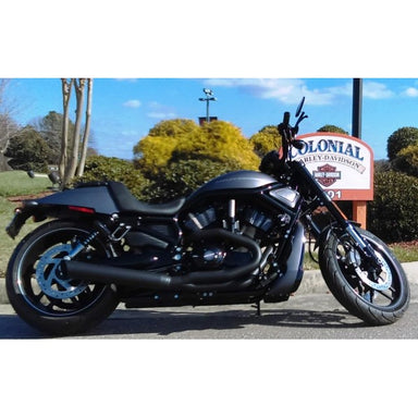 Black motorcycle parked on a road with a Colonial Harley-Davidson sign in the background.