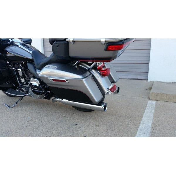 Motorcycle parked on a concrete surface with a white wall in the background