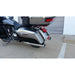 Motorcycle parked on a concrete surface with a white wall in the background