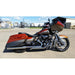 Motorcycle parked on a concrete surface with a building and sky in the background