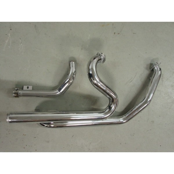 Set of chrome exhaust pipes on a gray surface