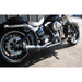 Black motorcycle parked on a concrete surface with a building in the background