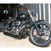 Black motorcycle parked in front of a metal building.