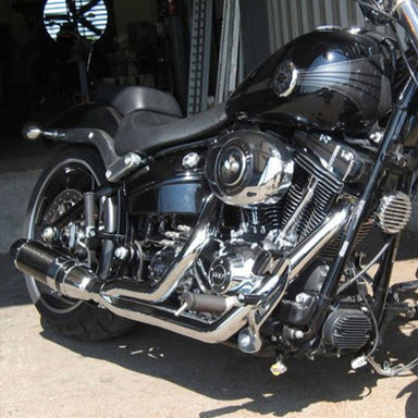 Black motorcycle with chrome details parked on a concrete surface.