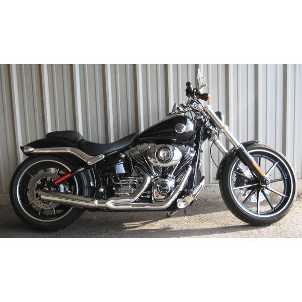 Black motorcycle parked on a concrete surface with a corrugated metal wall in the background
