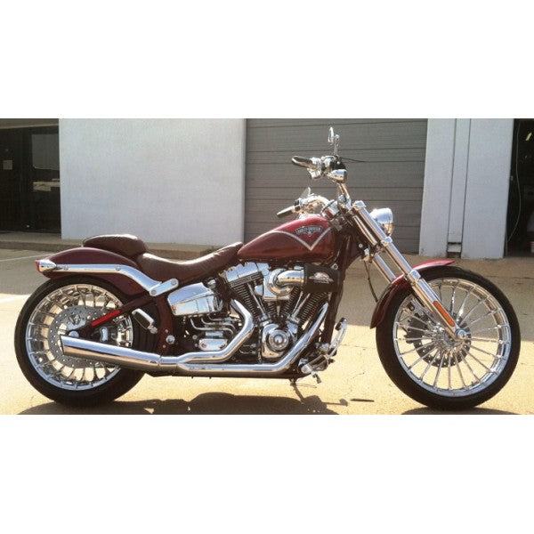 Motorcycle parked on a concrete surface with a building in the background