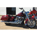 Red motorcycle with chrome details parked on a concrete surface.