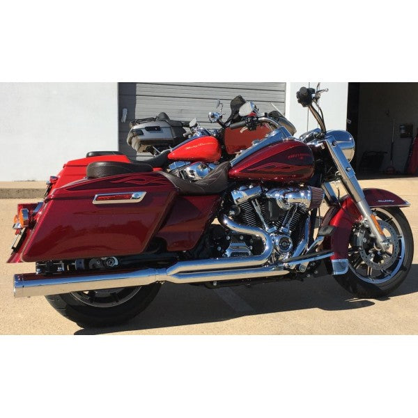 Red motorcycle with chrome details parked on a concrete surface.