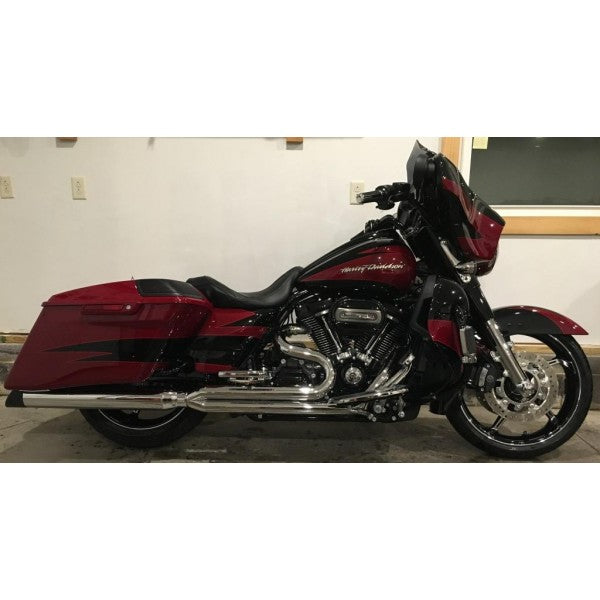 Red and black motorcycle parked indoors with a neutral background
