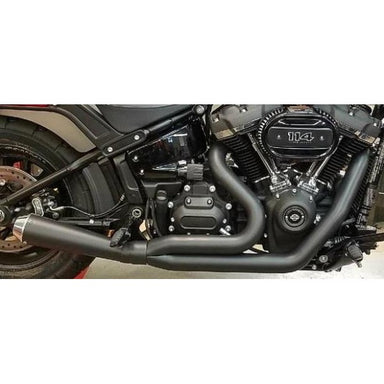 Close-up of a motorcycle engine and exhaust system on a white background