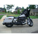 Harley Davidson motorcycle parked on a driveway with houses in the background