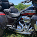 Harley Davidson motorcycle with chrome engine and leather seats on grass