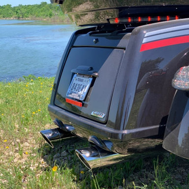 Back of a vehicle with a Texas license plate by a body of water