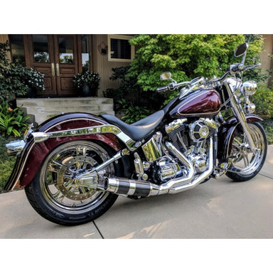 Maroon motorcycle parked on a driveway with a house in the background