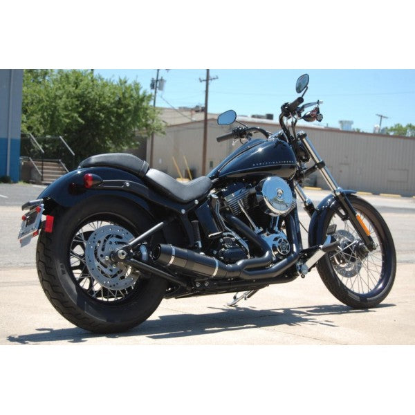 Harley-Davidson motorcycle parked on a concrete surface with a building and trees in the background.