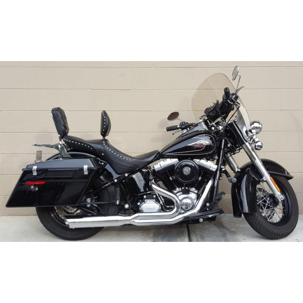 Black motorcycle parked against a beige wall