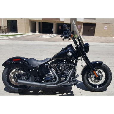 Black motorcycle parked on a street with a building in the background