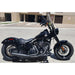 Black motorcycle parked on a street with a building in the background