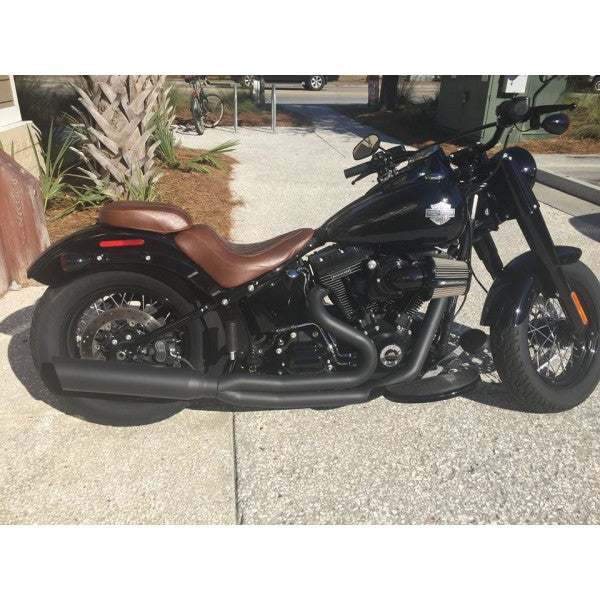 Black motorcycle with brown seat parked on a concrete surface.