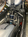 Close-up of a motorcycle engine and suspension system.