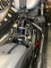 Close-up of a motorcycle engine and suspension system.