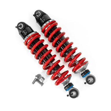 Pair of red and black shock absorbers on a white background