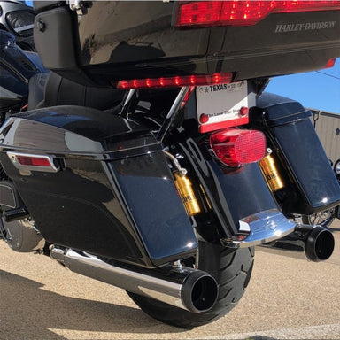 Close-up of a black motorcycle with visible Harley-Davidson branding, exhaust pipes, and taillights.