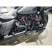 Gray motorcycle with visible engine and exhaust on a concrete floor.