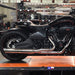 Black motorcycle on a lift in a garage setting