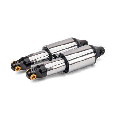Two metallic shock absorbers on a white background