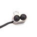 Small electronic component with two black buttons and a cable on a white background