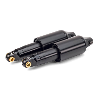 Two black shock absorbers with gold accents on a white background