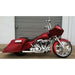 Red motorcycle with a sidecar parked in front of a garage door.