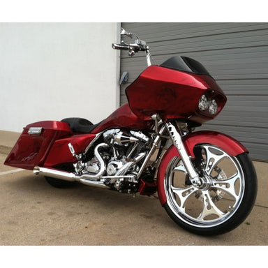 Red motorcycle parked in front of a gray building